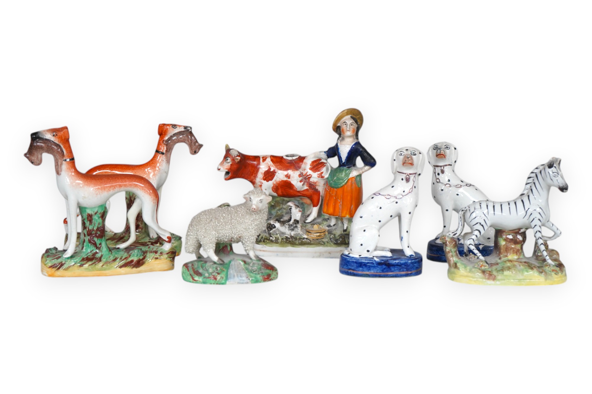 Eight Staffordshire figures to include a pair of Dalmatian’s and a cow creamer figure, largest 18cm wide. Condition - varies, poor to good